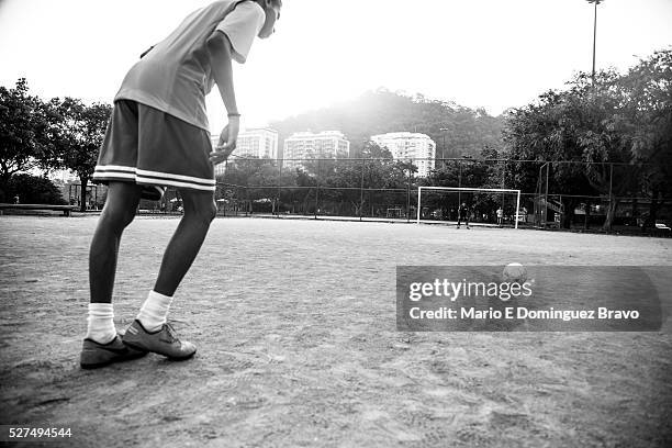 Two boys playing football in one of the courts of Lagoa. It is the 16th, the first day in which no scheduled World Cup matches. One day before the...