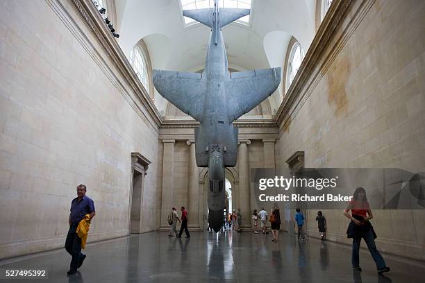 Visitors ponder the installation of artist Fiona Banner's fighter jet art work 'Harrier and Jaguar' which is exhibited in the south Duveens gallery...