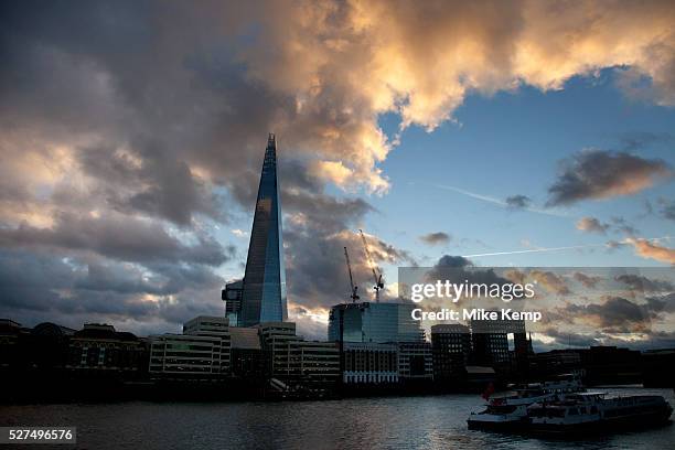 London's latest skyscraper, the Shard on the south side of the city near London Bridge against a strong cloud filled sky. The tallest building in...