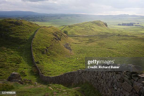 Wide landscape of Roman Hadrian's Wall, once the northern frontier of Rome's empire from Barbarian tribes. Hadrian's Wall was a stone and timber...