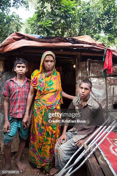 Dhaka, Bangladesh. Sjojun, 14 years old, lost the use of his legs due to polio and CSID provides him with crutches. He lives with his mother and...