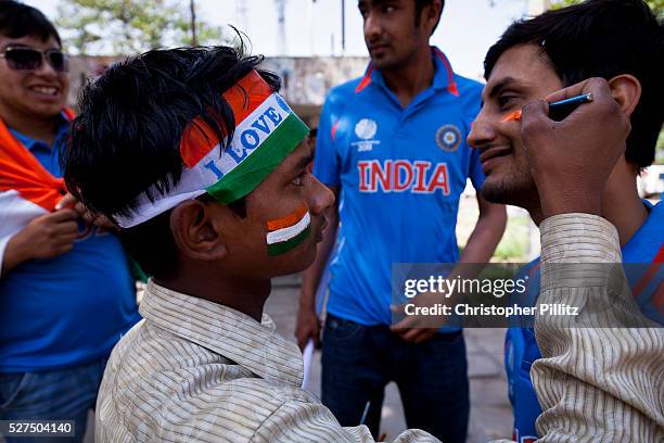 India fans have face paint applied just before the ICC 2011 Cricket World Cup semi final match between their team and Pakistan, Mohali, India