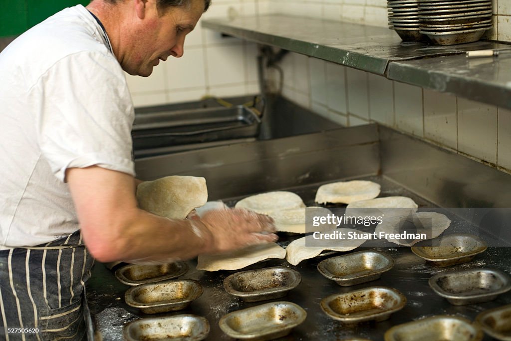 F. Cook Paddy, the baker in F Cooke's Pie and Mash shop making pies. Broadway ...