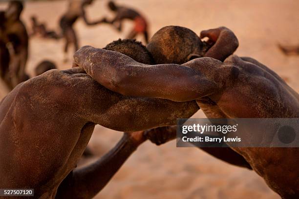 Young wrestlers training on the sand in the village of Dionewar situated on a desert island in the mouth of the river Saloum, Senegal No visit to...