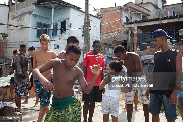 Young men guys on a rooftop dancing passinho to funk Carioca, Baile funk, Vila Valquiere, West Zone Zona Oueste, Rio de Janeiro