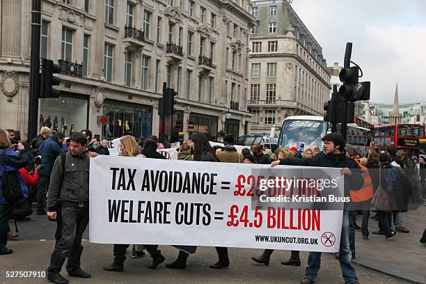 And UK Uncut staged a protest against Government cuts on disability benefits. A number of wheel chair bound activists locked themselves together and...