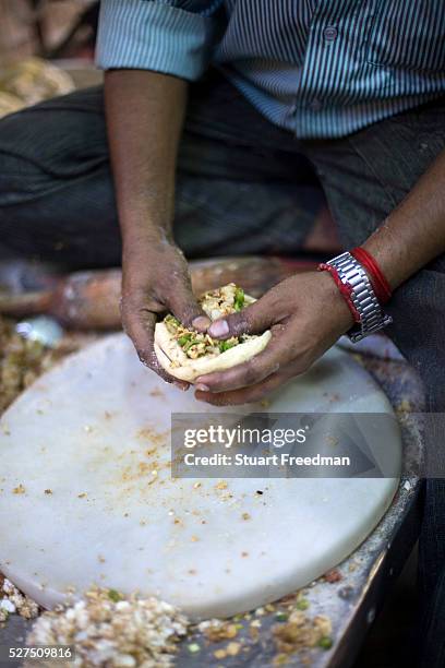 Ram Billas making paratha at Parawthe Wala restaurant in Old Delhi, India The parantha is an Indian fried bread, folded and filled with fillings and...