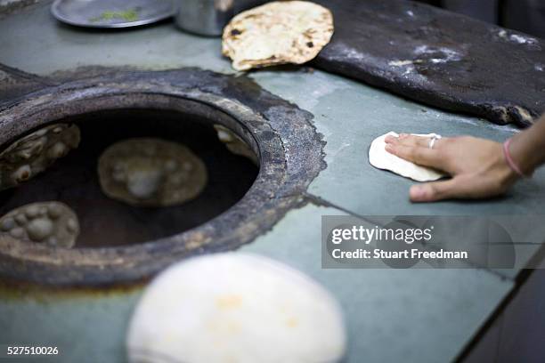 Chapati breads in the tandoor oven at the Village Restaurant in Siri Fort, New Delhi