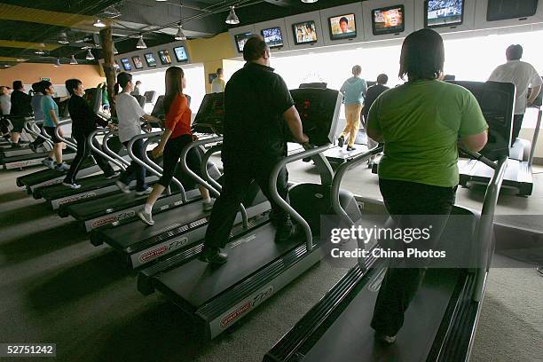 Overweight patients take part in a physical exercise lesson at the Aimin Acupuncture Weight Loss Hospital on May 2, 2005 in Tianjin, China. The...
