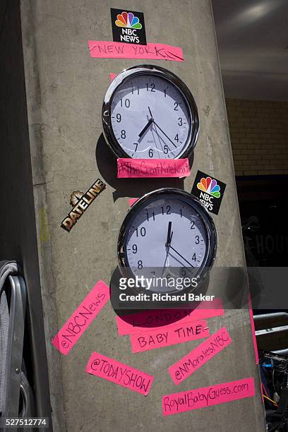 Time zone clocks in media village behind railings as tension mounts outside St Mary's Hospital, Paddington London, where media and royalists await...