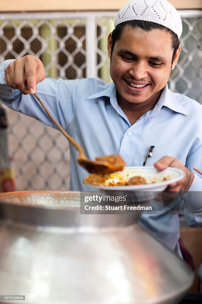 India - Delhi - A man serves Mutton Korma at the Al Jawahar Restaurant on Matia Mahal