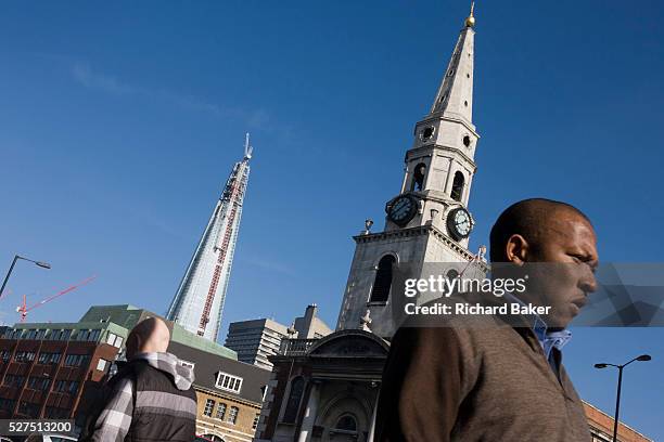 The almost-complete Shard skyscraper is seen alongside the spire of St George the Martyr church at Marshalsea. The Shard is a skyscraper under...