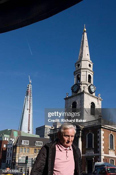 The almost-complete Shard skyscraper is seen alongside the spire of St George the Martyr church at Marshalsea. The Shard is a skyscraper under...