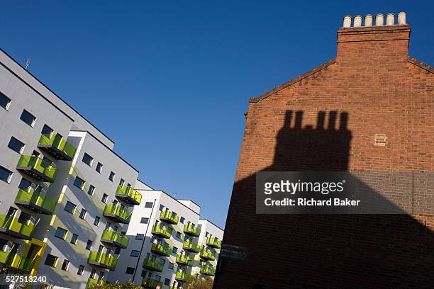 Old Edwardian brick housing alongside new apartments in a block developed by Skanska in Coldharbour Lane in Camberwell, Lambeth, South London. The...