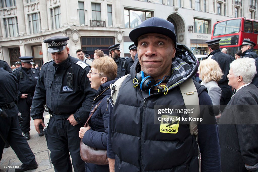 UK - London - Musician Goldie makes a face to camera surrounded by police