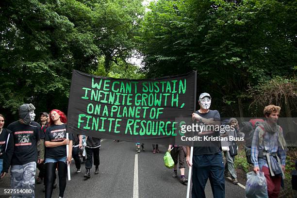 Eco-activists walk down London Road to join the 'Reclaim the Power' camp on the day of the swoop. The camp is set up in a field in solidarity with...