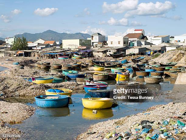 Mixture of traditional bamboo and modern plastic coracle fishing boats at the harbour in the coastal fishing village of Chi Cong in Central Vietnam