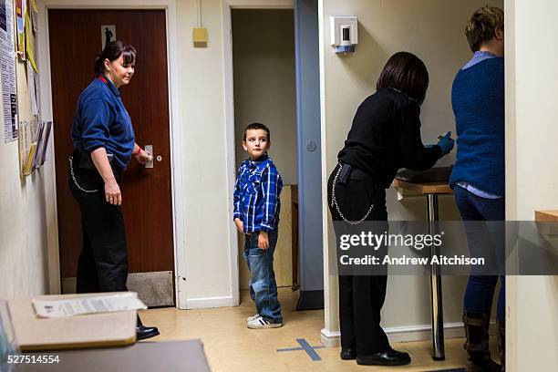 The partner and children of a prisoner go through the search process to get into a family visit session. HMP/YOI Portland, Dorset. A resettlement...