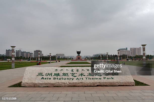 Sign welcomes visitors to the Asia Statutory Art Theme Park in Kangbashi New District of Ordos City, Inner Mongolia, China on 16 August, 2011. With...