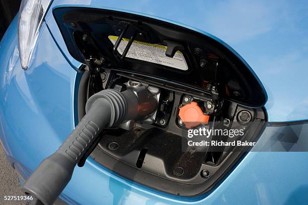 Fast charging a Nissan Leaf electric car at an electrical charging point offering an EV 30 minute charge at a south London Nissan dealership. The...