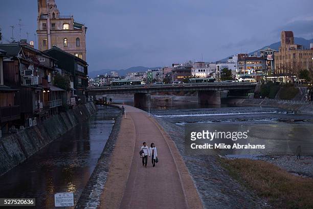 Couple taking an evening stroll down the banks of the Kamogawa River,