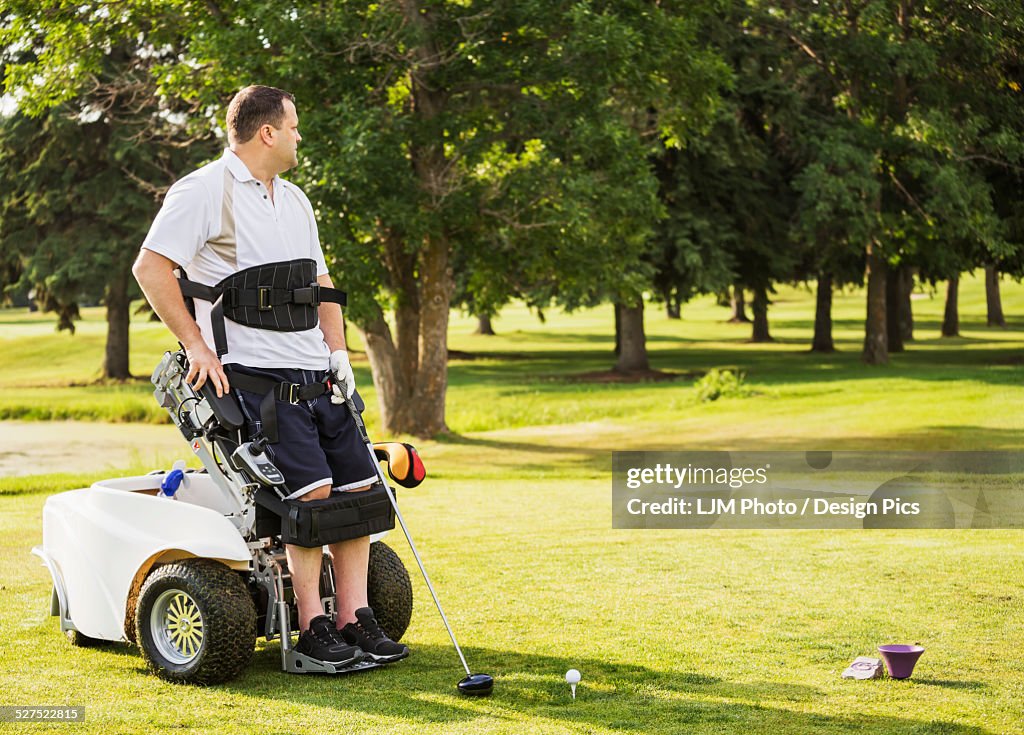 Disabled golfer in a tournament using high tech mobility aid