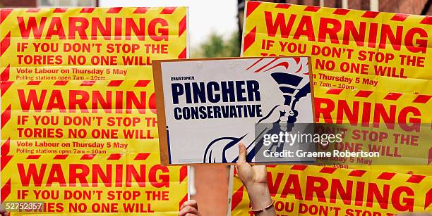 Conservative party supporter holds up a lone placard infront of anti-conservative posters on May 3, 2005 in Tamworth, England. The battle to win over...