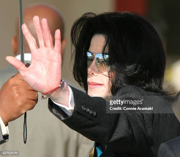Singer Michael Jackson gestures as he arrives at the Santa Barbara County Superior Court for his child molestation trial May 3, 2005 in Santa Maria,...