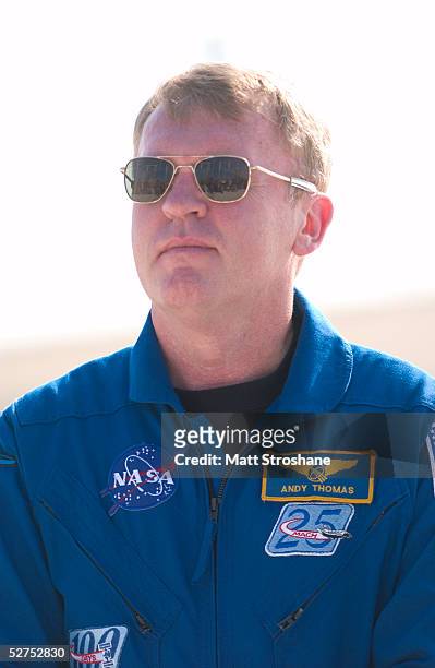 Space Shuttle Discovery mission specialist Andrew Thomas of Adelaide, South Australia addresses the media in front of the shuttle on launch pad 39B...