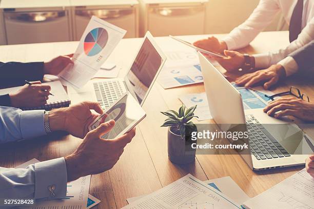 group of people meeting with technology. - business finance and industry stock pictures, royalty-free photos & images