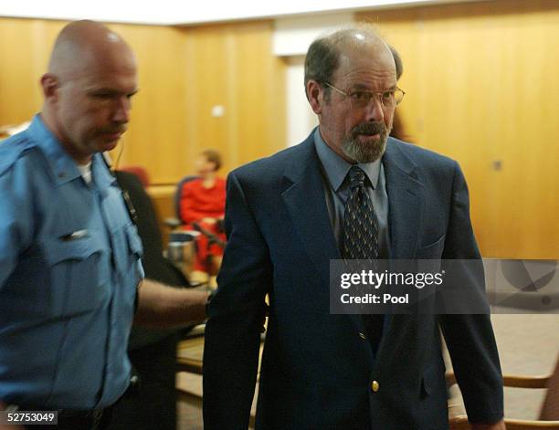 Dennis L. Rader , suspected of being the BTK serial killer, is escorted from the Sedgwick County courtroom after his arraignment May 3, 2005 in...