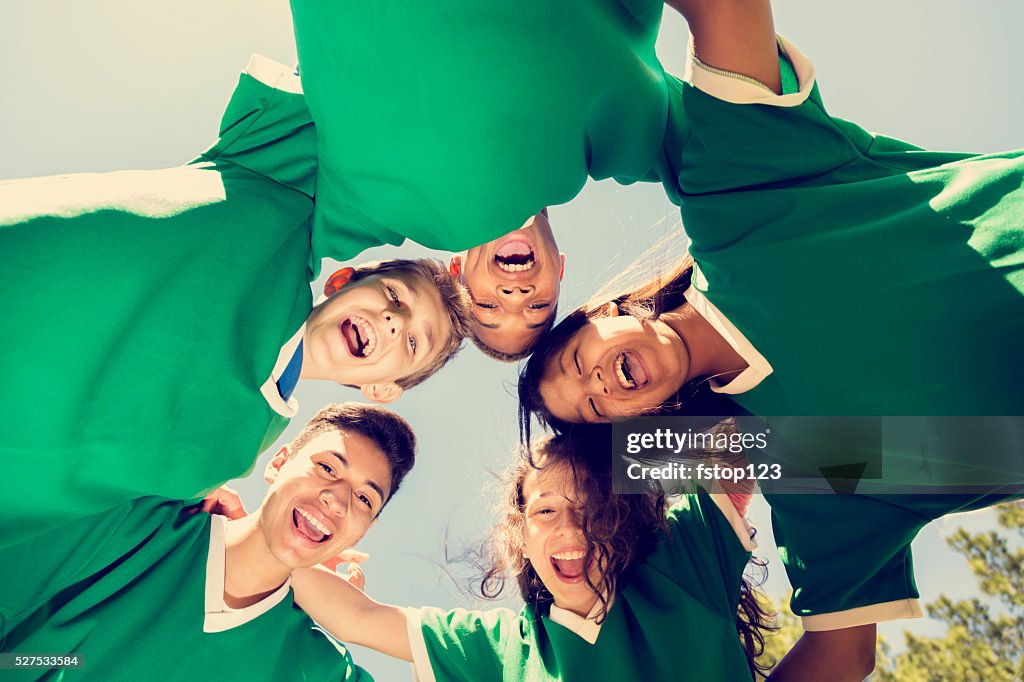 Sports: Teenage friends soccer team with sky, park background.