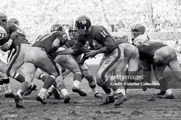 Quarterback YA Tittle of the New York Giants, hands the ball to runningback Dick James during a game against the Cleveland Browns on December 12,...