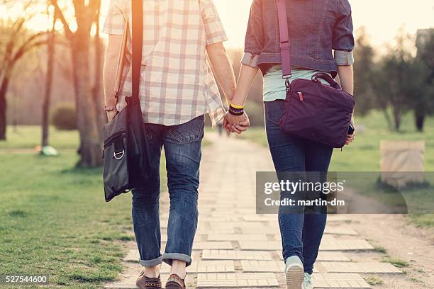 rear view of teenage couple in the park - teenage couple 個照片及圖片檔