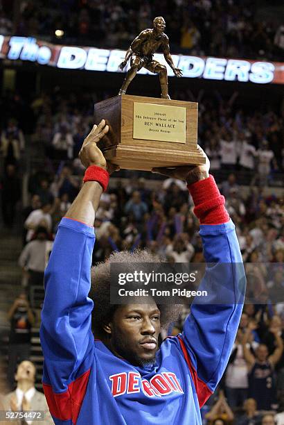 Ben Wallace of the Detroit Pistons holds up his NBA Defensive Player of the Year Award given to him prior to the start of Game five of the Eastern...