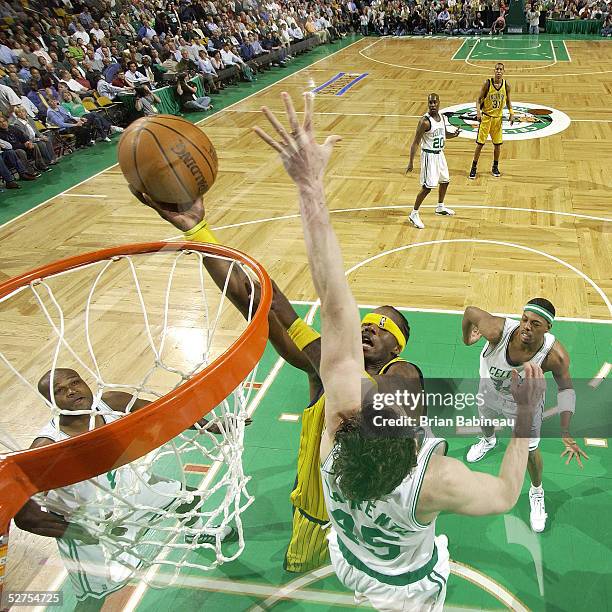 Jermaine O'Neal of the Indiana Pacers blinded by his own headband with Raef LaFrentz of the Boston Celtics on defense in Game five of the Eastern...