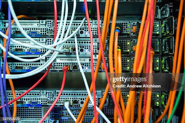 Large mass of multi-colored computer cables in a server room in a British business office in London, United Kingdom.