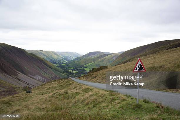 View along a valley in the Cambrian Mountains from a point of natural beauty towards Llanymawddwy. Wales, UK. A warning sign showing that there may...
