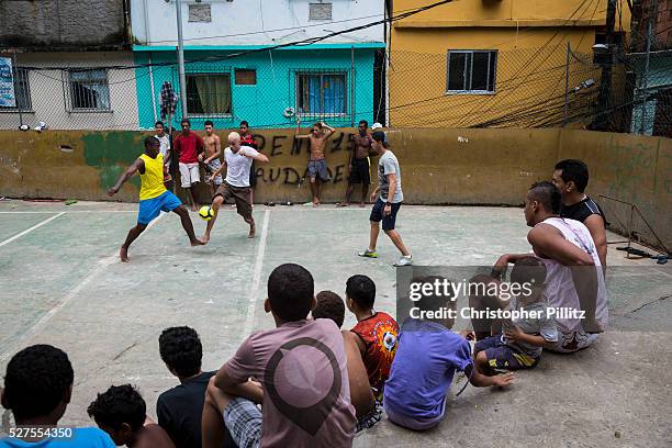 Inside Rocinha favela boys play "futsal", also known as "society" football. Football, Samba and Carnival harness the community spirit, Rio de Janeiro.