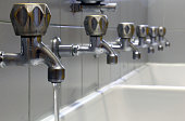 tap with water and many taps shut