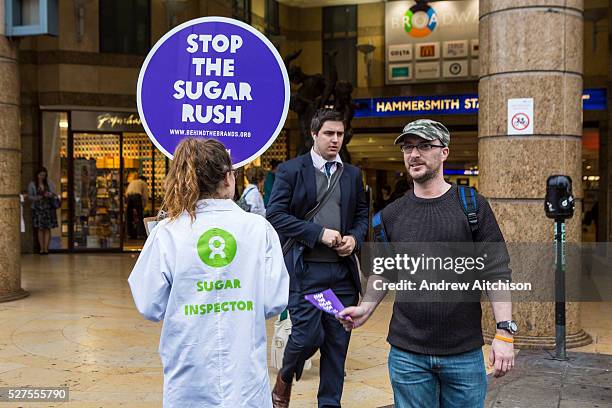 Oxfam supporters outside Hammersmith Tube station and the Coca Cola headquarters, calling for the company to tighten its supply chain so that the...