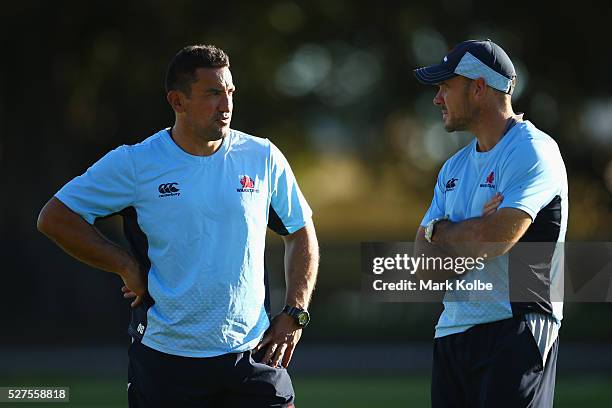 Waratahs coach Daryl Gibson speaks to assistant coach Nathan Grey during a Waratahs Super Rugby training session at Kippax Lake on May 3, 2016 in...