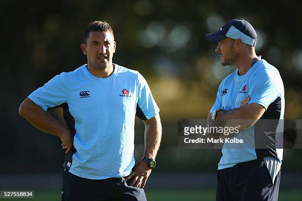 Waratahs coach Daryl Gibson speaks to assistant coach Nathan Grey during a Waratahs Super Rugby training session at Kippax Lake on May 3, 2016 in...