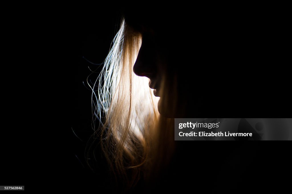 Silhouette of woman's face at night