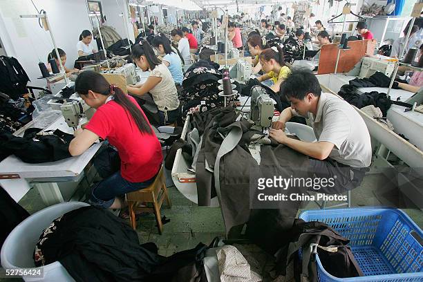 Chinese labourers work at a garment factory on May 4, 2005 in Shenzhen of Guangdong Province, China. The expiry of the global textile quota system...