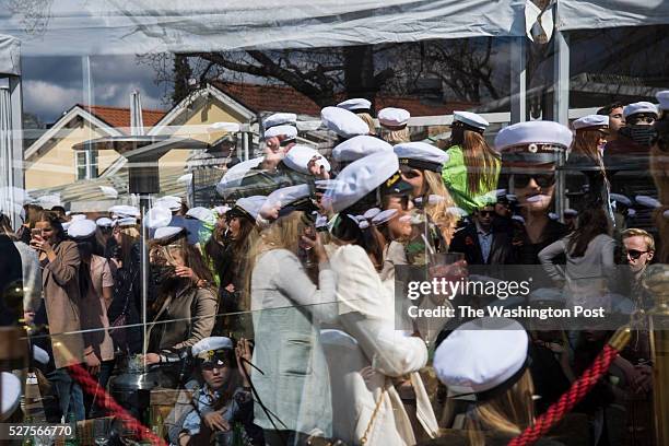 High School students wear their traditional white graduate caps during a graduation party at Restaurang Josefina in Stockholm, Sweden on Friday April...