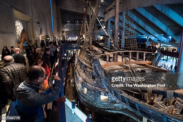 People walk around and look in a museum for the well-preserved, 17th-century warship, Vasa, that sank on her maiden voyage in 1628 in Stockholm,...