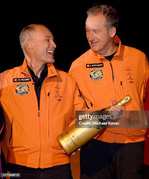 Solar Impulse 2 pilots Bertrand Piccard and Andre Borschberg celebrate after Borschberg landed their solar-powered plane at Phoenix Goodyear Airport...