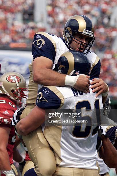 Offensive guard Tom Nutten of the St. Louis Rams celebrateswith teammate Jeff Robinson during their game against the San Francisco 49ers at 3Com Park...