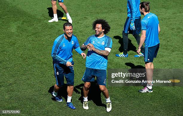 Cristiano Ronaldo of Real Madrid shares a joke with Marcelo of Real Madrid during a training session ahead of the UEFA Champions League Semi Final...